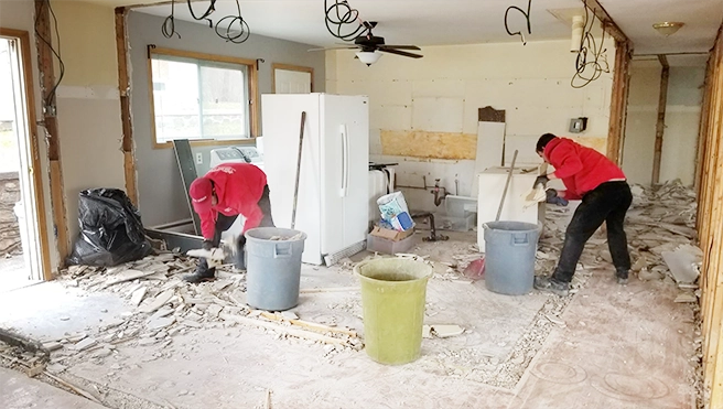 Two Junk King professionals remodeling a kitchen.
