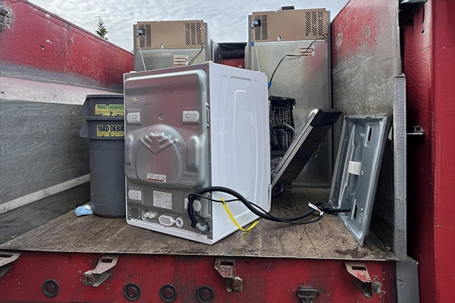 Appliances loaded onto the back of a truck.