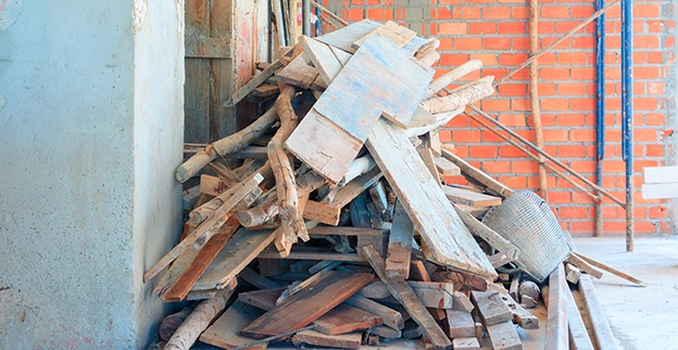 A pile of boards on a cement porch.