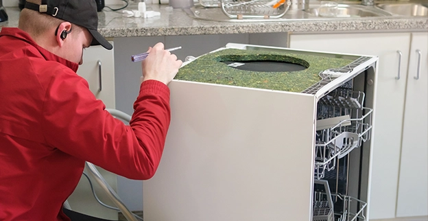 Junk King professional removing a dishwasher.