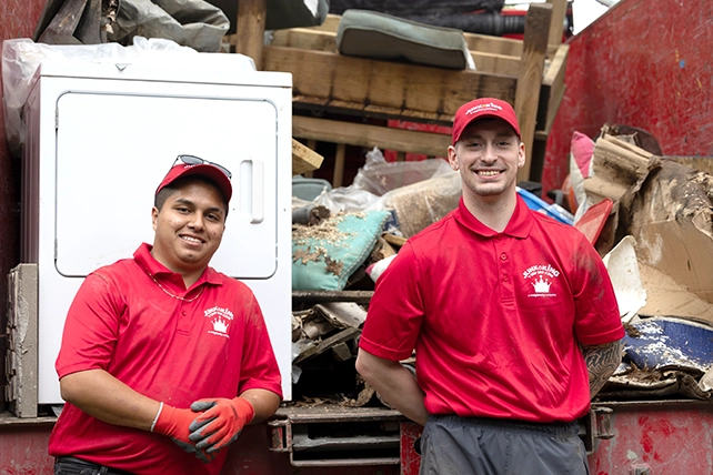 Two Junk King professionals smiling for the camera.