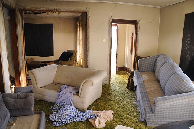 A living room with old couches.