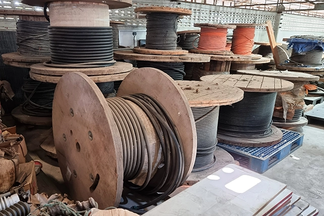 Large wooden spools of hose.