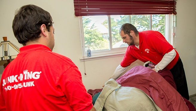 Junk King professionals removing junk from a business.