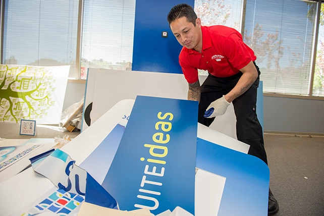 Junk King professional removing signage from an office building.