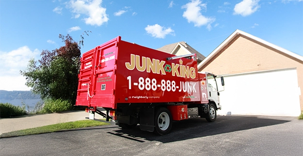 Red dump truck parked outside of a home.