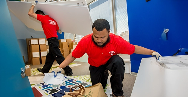 Two Junk King professionals cleaning out a commercial property.