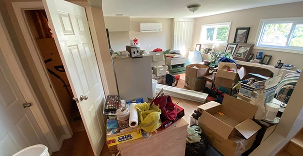 A messy room full of boxes and junk.