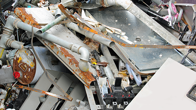 A pile of scrap metal outside.