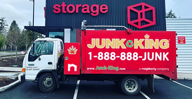The front of a storage unit with a Junk King truck parked beside it.