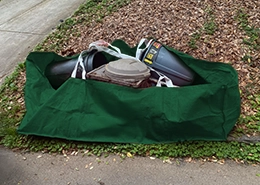Green dumpster bag ready for pickup.