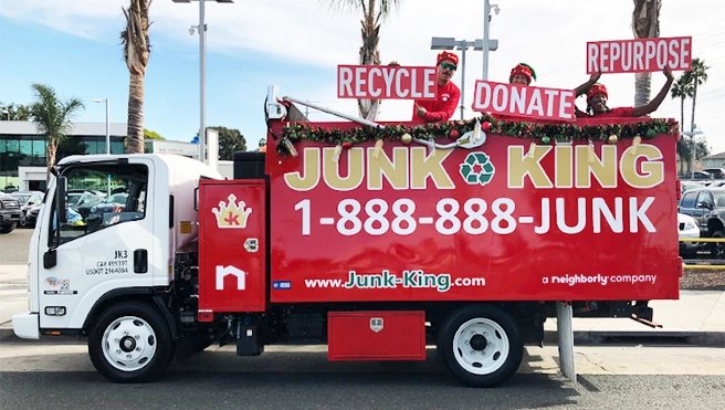 Junk King work truck with business information displayed on the side.
