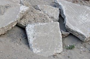A pile of gray concrete blocks stacked on the ground