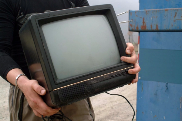 Holding old tv in hand